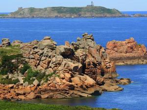 a rocky island in the middle of the water at Bel Appartement 3* au Centre de Perros-Guirec avec WIFI, Balcon et Parking - FR-1-368-337 in Perros-Guirec +11 photos
