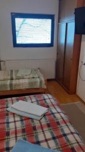 a small room with a bed and a window at Apartment Gajevi in Zlatibor