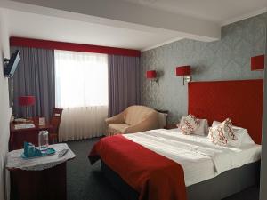 Postel nebo postele na pokoji v ubytování Amigo Hotel
