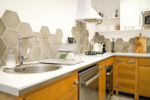 a kitchen with a sink and a counter top at Le doux refuge - SPA privatif - Romantique - Calme in Châteauroux