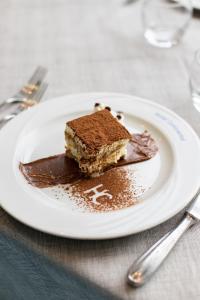 un pezzo di torta al cioccolato su un piatto su un tavolo di Hotel Continental a Tortoreto