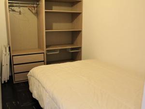 a bedroom with a bed and an empty closet at Appartement Vars, 2 pièces, 6 personnes - FR-1-330B-9 in Vars