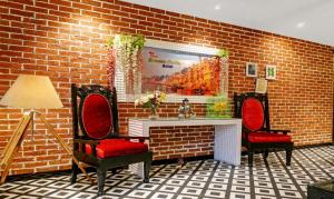 a room with two chairs and a brick wall at Itsy By Treebo - Banana Boutique in Varanasi