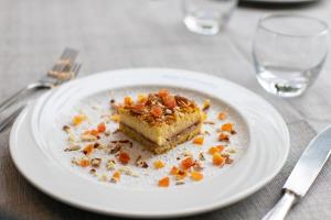 a white plate with a piece of cake on a table at Hotel Continental in Tortoreto Lido