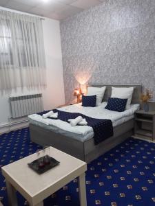 a bedroom with a large bed and a table at Lind Guest House B&B in Gyumri