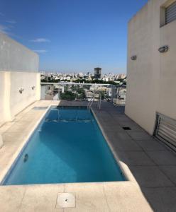 a swimming pool on the roof of a building at Estudio minimalista, moderno, confortable, luminoso con piscina in Buenos Aires