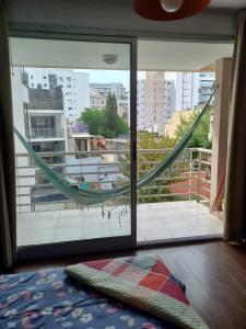 a room with a view of a balcony with a hammock at Estudio minimalista, moderno, confortable, luminoso con piscina in Buenos Aires