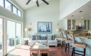 a living room with a couch and a table at Oceanfront Condo with 3+ Pools - Ocean Dunes 1507 in Kure Beach +40 photos