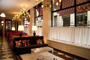 a lobby with a couch and a chandelier at Tango de Mayo Hotel in Buenos Aires