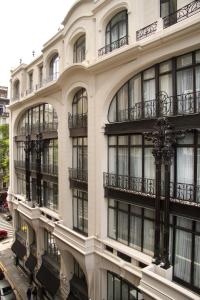 a large white building with balconies on the side of it at Tango de Mayo Hotel in Buenos Aires