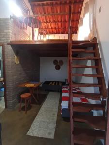 a room with a bunk bed and a staircase at Canto Ybykuara - Natural Guest House in Ibicoara