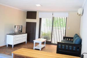 a living room with a couch and a table at Solaire Carrodilla in Ciudad Lujan de Cuyo