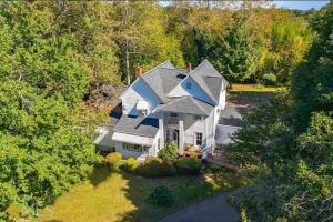 an aerial view of a large white house at 1875 Historic Manor, 5 Acres Near Helen & Wineries in Baldwin