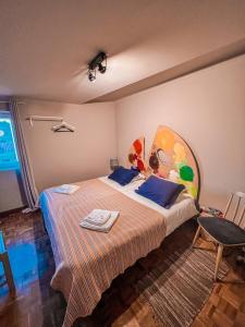 a bedroom with a bed with a surfboard on it at Casas Sebastião - Tourist House in Caminha