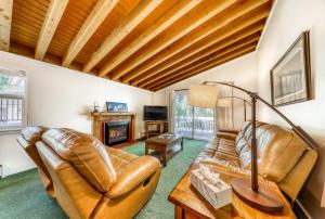 a living room with leather furniture and a fireplace at Single Level Ranch Condo in Elkhorn in Sun Valley