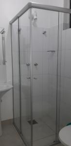 a glass shower in a bathroom with a toilet at BH EXPO SUITES & KITNETES in Belo Horizonte