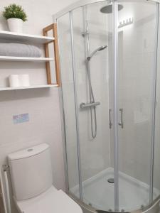 a bathroom with a glass shower with a toilet at Le Gîte Senlisien in Senlis +39 photos