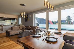 a kitchen and living room with a table and chairs at A&V Apartments Wunderschöne Penthouse Wohnung in Moers