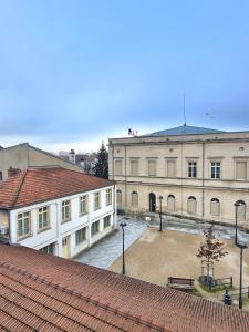 a large building with a courtyard in front of it at Victoire émeraude 301 hôtel de ville in Saint-Dizier