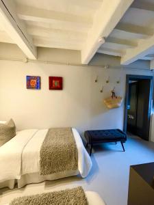 a bedroom with a bed and a bench in a room at Casa Valeria - Guest House Centro Storico in Fano