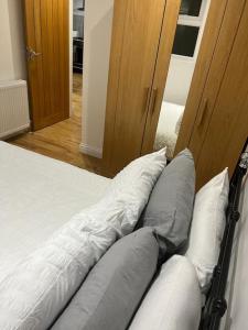 a bedroom with a bed with pillows on it at 2 bedroom apartment in HampdenRd in London