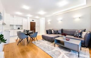 a living room with a couch and a table at Wilanów Dream & Heaven Apartments in Warsaw