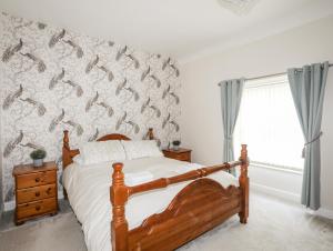 a bedroom with a bed with a fish wall at 6 Erasmus Street in Penmaen-mawr