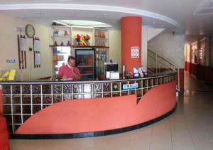 a man standing at the counter of a store at Hotel Paraiso Belém in Belém