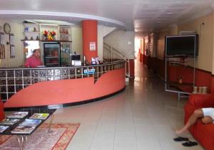eine Lobby eines Ladens mit einer Theke und einer Person in der Unterkunft Hotel Paraiso Belém in Belém