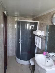 a bathroom with a shower and a sink at Hotel Estación Náutica - Aeropuerto in Punta Arenas