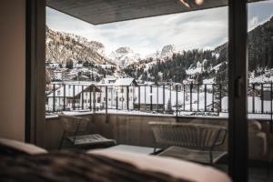 a view of a snowy mountain from a balcony at Avita Loft by Avita suites to relax in Santa Cristina in Val Gardena