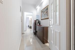 a hallway with white walls and a white door at ATHENAIS CENTRAL in Litochoro