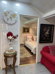 a bedroom with a bed and a vase of flowers on a table at Appartement T LUXE in Pierrefitte-sur-Seine