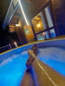 a person in a hot tub in a house at Guané Glamping & Ecolodge - Oriente Antioquia in Guarne