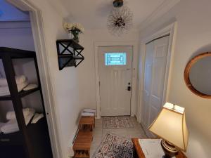 a hallway with a door and a table and a lamp at Comfy and Chic Boston Apartment! in Boston