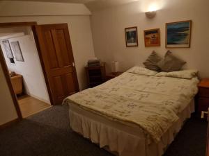 a bedroom with a large bed in a room at The Hillock in Uplawmoor