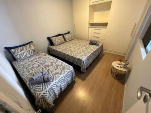 um pequeno quarto com duas camas num quarto em UNU 1003 - Ondina, Carnaval, Orla, Vista, Wi-fi e+ em Salvador