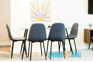 four chairs and a glass table in a room at Dallas Business Suite - Petremote Work in Dallas