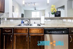 a kitchen with a sink and a dishwasher at Dallas Business Suite - Petremote Work in Dallas