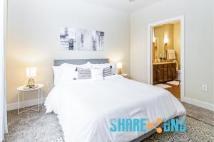 a bedroom with a large white bed and a mirror at Dallas Business Suite - Petremote Work in Dallas