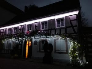 a lit up house with christmas lights on it at Moulin de Schwabwiller in Schwabwiller