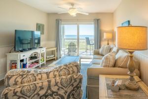 a living room with a couch and a television at Sands IV 2-G in Carolina Beach