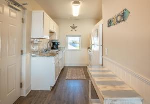 a kitchen with white cabinets and a white refrigerator at Sands IV 2-G in Carolina Beach