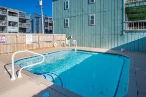 a swimming pool on the deck of a building at Sands IV 2-G in Carolina Beach