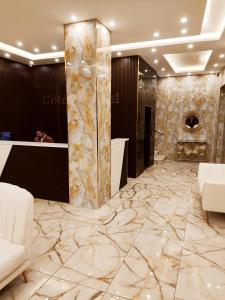 a lobby of a hotel with marble flooring and a bar at Golden Hotel in Amman