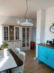 a kitchen with a table and a blue cabinet at Villa Lorena in Sutivan