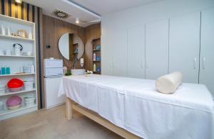 a white room with a table and a mirror at Hedonist Zlatibor Mountain Wellness & SPA in Zlatibor +18 photos