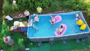 a group of people swimming in a swimming pool at Gästehaus Nachtigall in Gädheim
