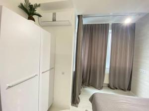 a bedroom with a bed and a sliding glass door at Business Double Room Lux Apartment in the Center in Chişinău