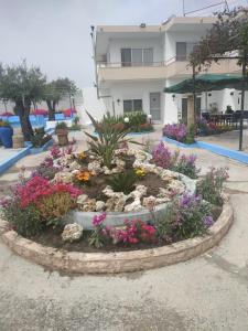a flower garden in front of a building at BELLA CASA KOLYMPIA in Kolymbia